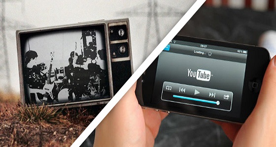 a black and white tv screen and someone watching youtube on a handheld device