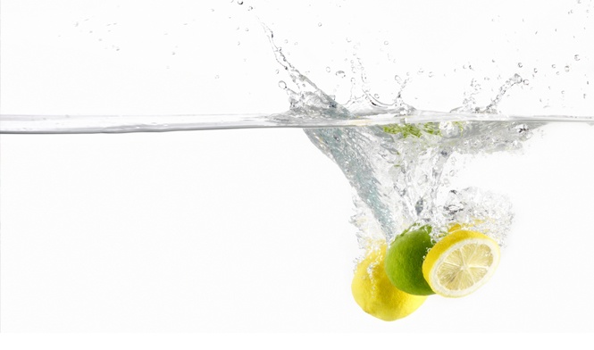 lemons that have been dropped into a bowl of water